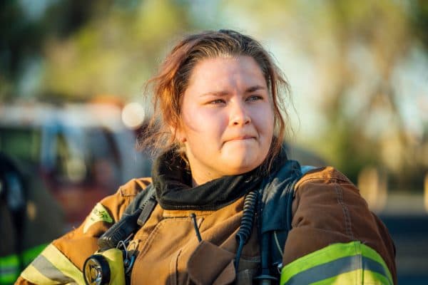 female firefighter in gear after fighting a fire