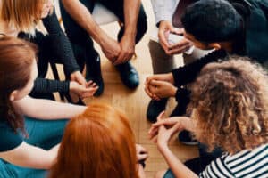 A group of participant sitting in a circle during group counseling