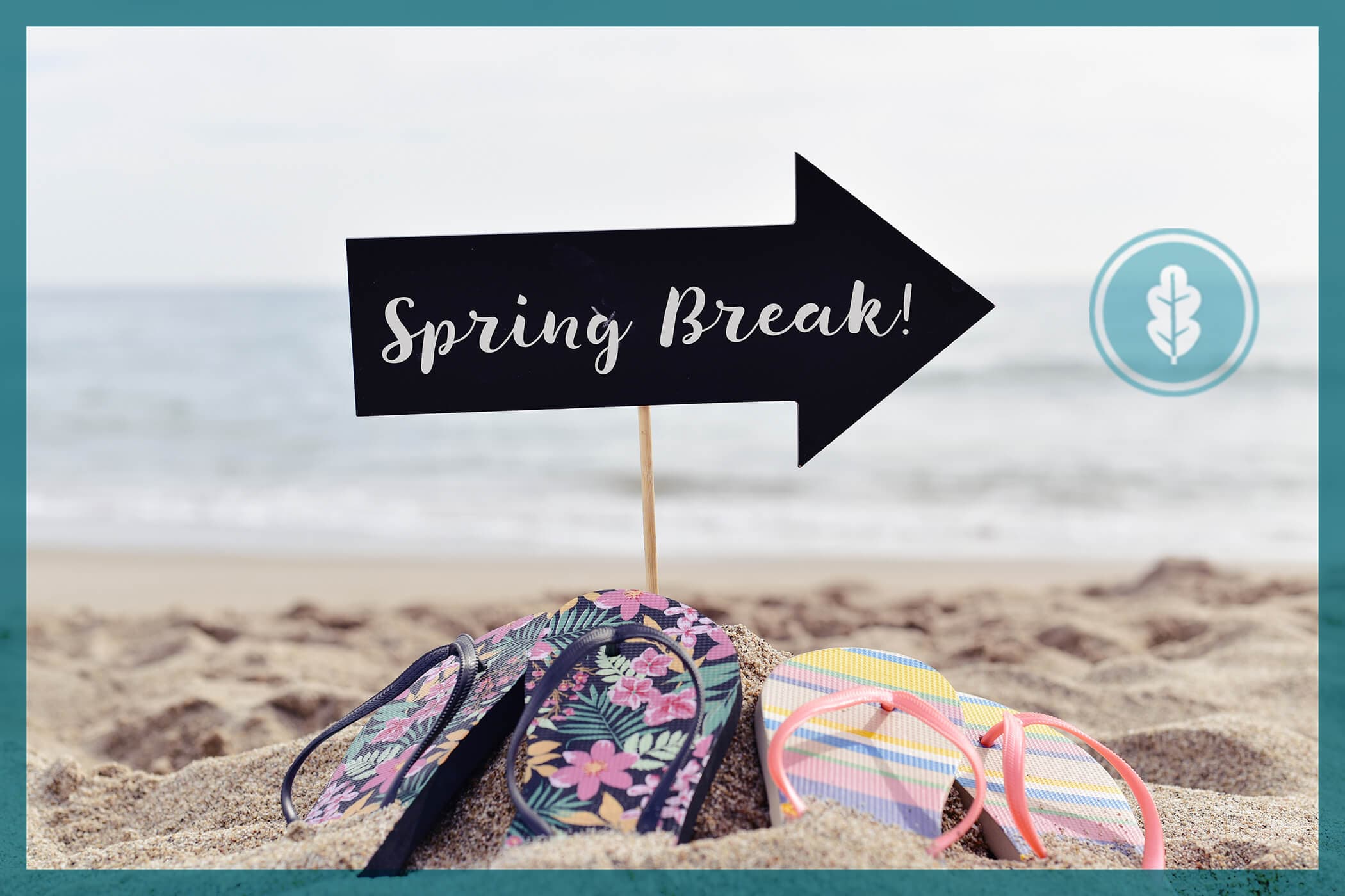spring break sign on the beach with two pairs of flip flops